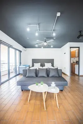 a living room with a couch and a table at P & I in Athens