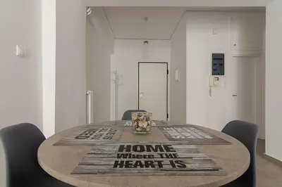 a dining room table with chairs and a home where the heart is at Renovated Apartment next to Panathenaic Stadium in Athens