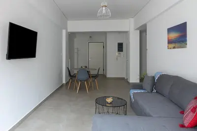 a living room with a couch and a table at Renovated Apartment next to Panathenaic Stadium in Athens