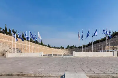 a large amphitheater with flags in the stands at Renovated Apartment next to Panathenaic Stadium in Athens