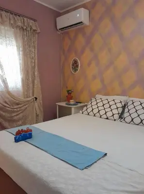 a bedroom with a bed with a blue ribbon on it at PARADISE in Dhaskalión