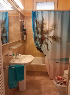 a bathroom with a sink and a shower curtain at PARADISE in Dhaskalión