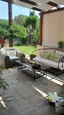 a couch and a coffee table on a patio at PARADISE in Dhaskalión
