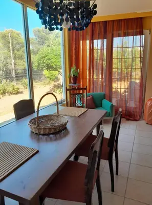 a dining room table with chairs and a basket on it at PARADISE in Dhaskalión