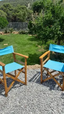 two blue chairs sitting next to each other at PARADISE in Dhaskalión