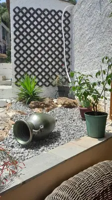a garden with a large green bowl on the ground at PARADISE in Dhaskalión