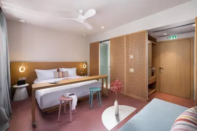 a bedroom with a bed and a desk in a room at Alkima Athens Wellness Stay in Athens