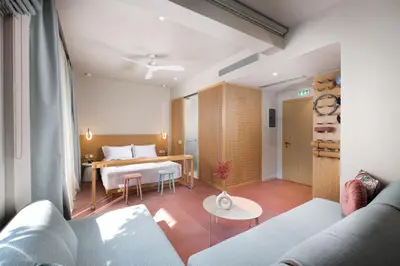 a living room with a couch and a bed at Alkima Athens Wellness Stay in Athens