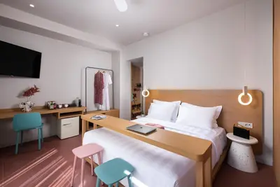 a hotel room with a bed with a desk and chairs at Alkima Athens Wellness Stay in Athens