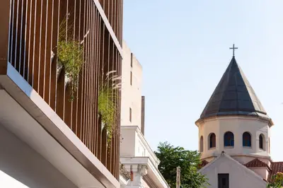 a church steeple with a cross on the top of a building at Alkima Athens Wellness Stay in Athens