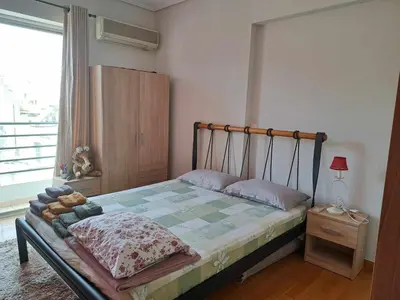 a bedroom with a bed and a window at Athens Christina's Acropolis Apartment in Athens