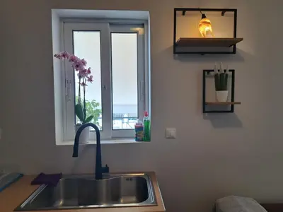 a kitchen counter with a sink and a window at Athens Christina's Acropolis Apartment in Athens