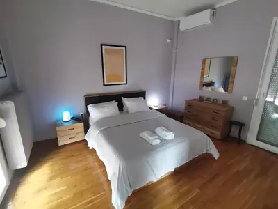 a bedroom with a bed with two towels on it at Penthouse spacious w super wifi & terrace, 2 min from metro in Athens