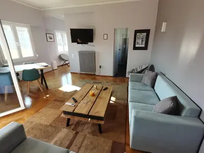 a living room with a couch and a coffee table at Penthouse spacious w super wifi & terrace, 2 min from metro in Athens