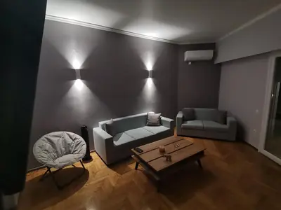 a living room with two couches and a coffee table at Penthouse spacious w super wifi & terrace, 2 min from metro in Athens