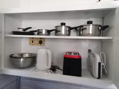 a kitchen with two pots and pans on a shelf at Penthouse spacious w super wifi & terrace, 2 min from metro in Athens
