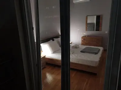a small bedroom with a bed with a mirror at Penthouse spacious w super wifi & terrace, 2 min from metro in Athens