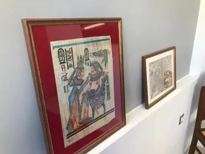 two framed artworks on a shelf on a wall at ROYAL RED SUITE NO 1, PIRAEUS PORT in Piraeus