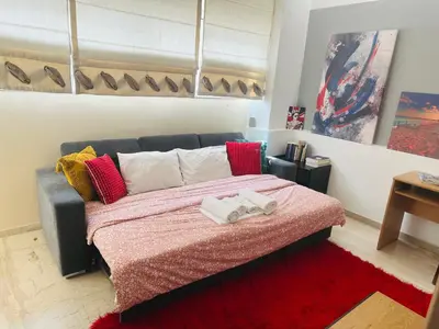 a bedroom with a bed with two towels on it at ROYAL RED SUITE NO 1, PIRAEUS PORT in Piraeus