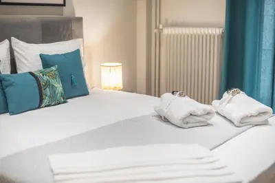 a bedroom with a bed with towels on it at Elegant Mavili Suite by CloudKeys in Athens