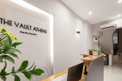 a dining room with a table and a sign on the wall at The Vault Athens in Athens