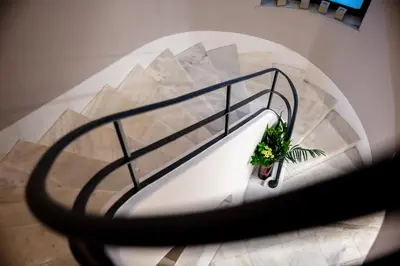 a view of a spiral staircase with a plant at The Vault Athens in Athens