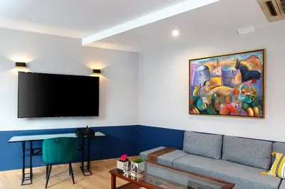 a living room with a couch and a flat screen tv at The Vault Athens in Athens