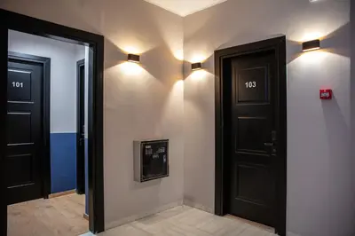 a hallway with two doors and lights on the wall at The Vault Athens in Athens