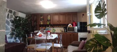 a kitchen with a table and chairs and a kitchen with a table and a kitchen at SHLEY House 1 in Artemida