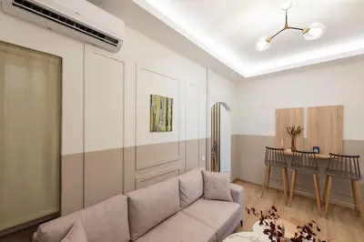 a living room with a couch and a table at MEDLUXE BUSINESS Apartment in Athens