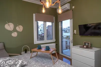 a bedroom with a bed and a tv and a table at Acropolis apartment with a unique view 2 in Athens