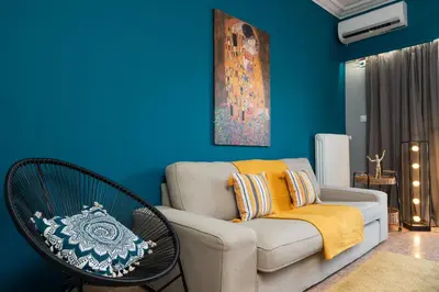 a living room with a couch and a chair at Acropolis apartment with a unique view 2 in Athens