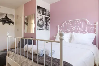 a bedroom with a white bed and pink walls at Cozy Studio in Koukaki Athens BY ZAIN in Athens
