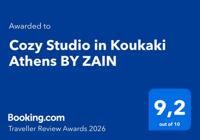 a blue sign with the words cozy studio in kokukka athens by at Cozy Studio in Koukaki Athens BY ZAIN in Athens