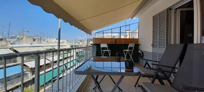 a balcony with a table and chairs on top of a building at Cozy Studio in Koukaki Athens BY ZAIN in Athens