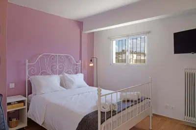 a bedroom with a white bed and a window at Cozy Studio in Koukaki Athens BY ZAIN in Athens
