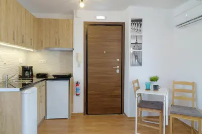 a kitchen with a wooden door and a table at Cozy Studio in Koukaki Athens BY ZAIN in Athens