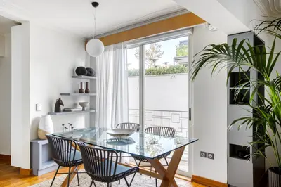a dining room with a glass table and chairs and a window at Monastiraki Stylish Loft W/ Acropolis View/Bathtub in Athens