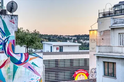a building with a mural on the side of it at Monastiraki Stylish Loft W/ Acropolis View/Bathtub in Athens