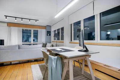 a living room with a couch and a desk with a computer at Monastiraki Stylish Loft W/ Acropolis View/Bathtub in Athens