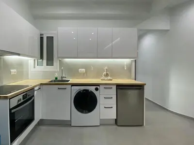 a white kitchen with a washing machine in it at Luxury 1 Bedroom Flat in Athens