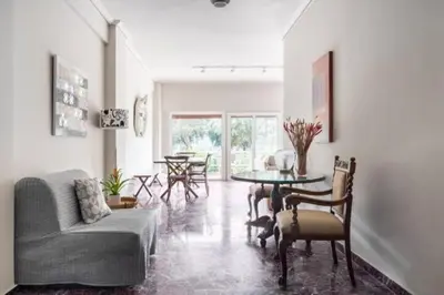 a living room with a couch and a table at Flisvos Marina refurbished apartment in Athens