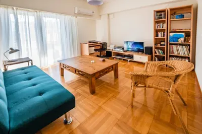 a living room with a couch and a table at 5th Floor Boho Quircky in Athens