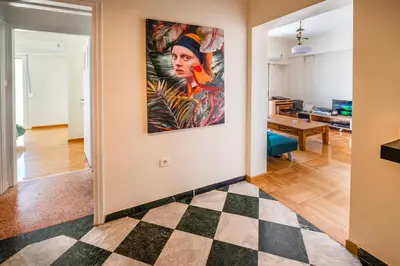 a living room with a large painting on the wall at 5th Floor Boho Quircky in Athens
