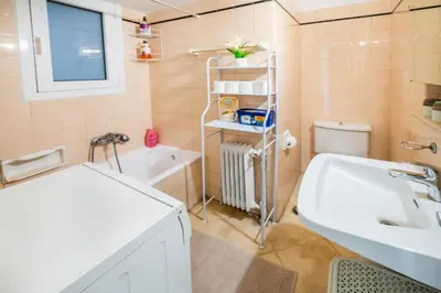 a bathroom with a sink and a toilet and a tub at 5th Floor Boho Quircky in Athens