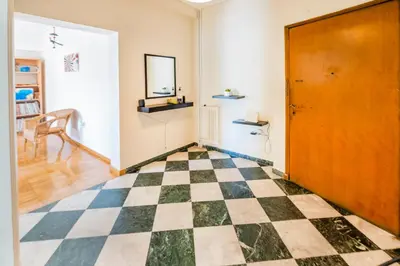 a room with a checkered floor and a door at 5th Floor Boho Quircky in Athens