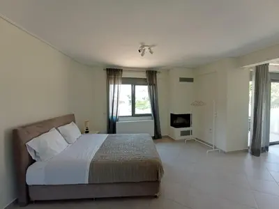 a bedroom with a bed and a tv in it at Andi's Studio Porto Rafti in Porto Rafti