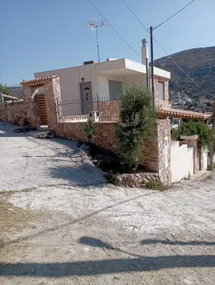 a house on a hill with a building at Andi's Studio Porto Rafti in Porto Rafti