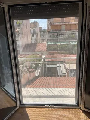 a window with a view of a roof at Your studio Athens in Athens