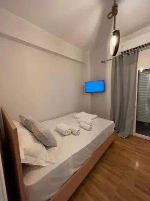 a bedroom with a bed with two towels on it at Your studio Athens in Athens